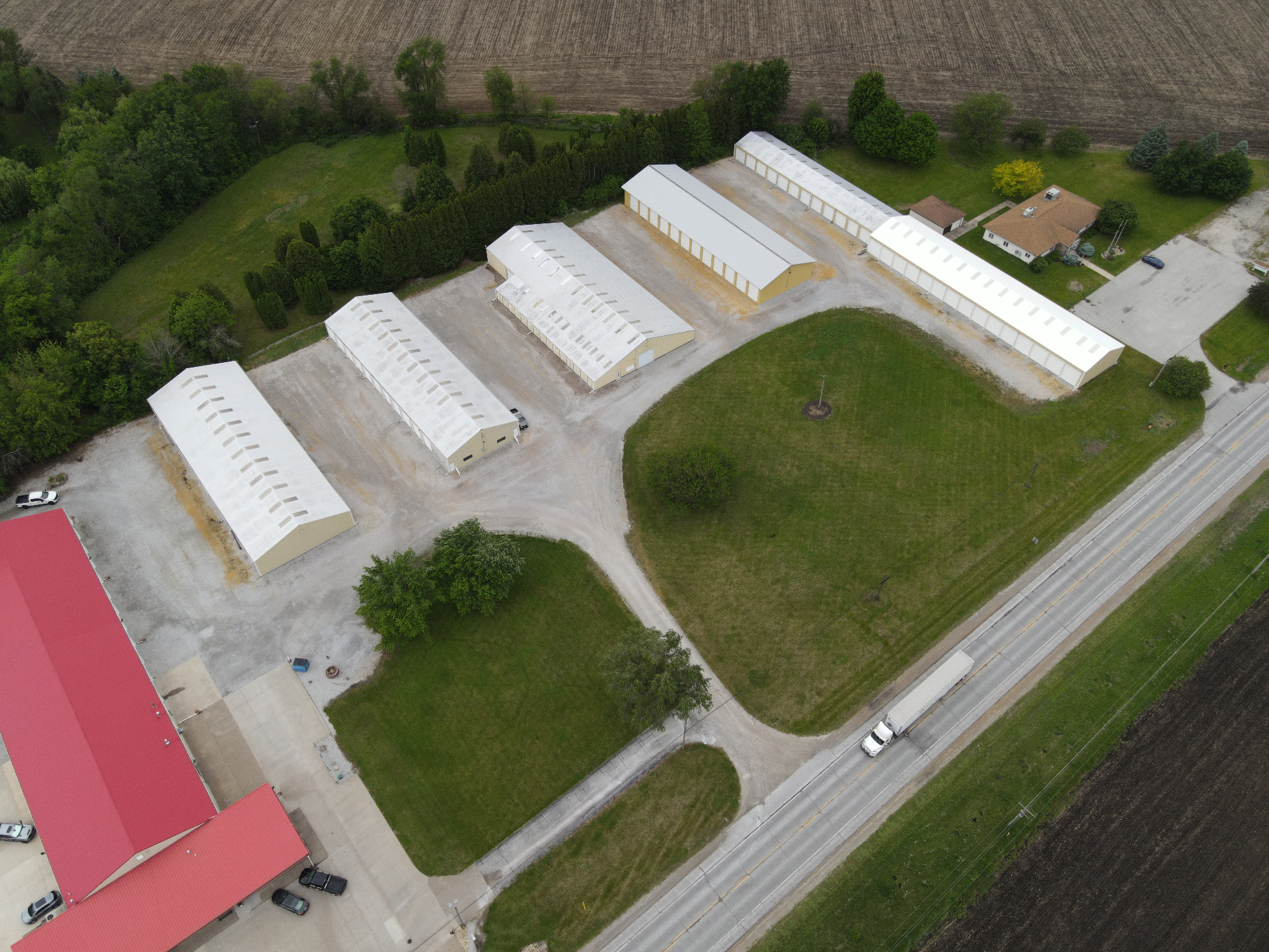 Aerial view of the QC Storage facility in West Davenport, Iowa, showing five storage buildings and paved drive aisles